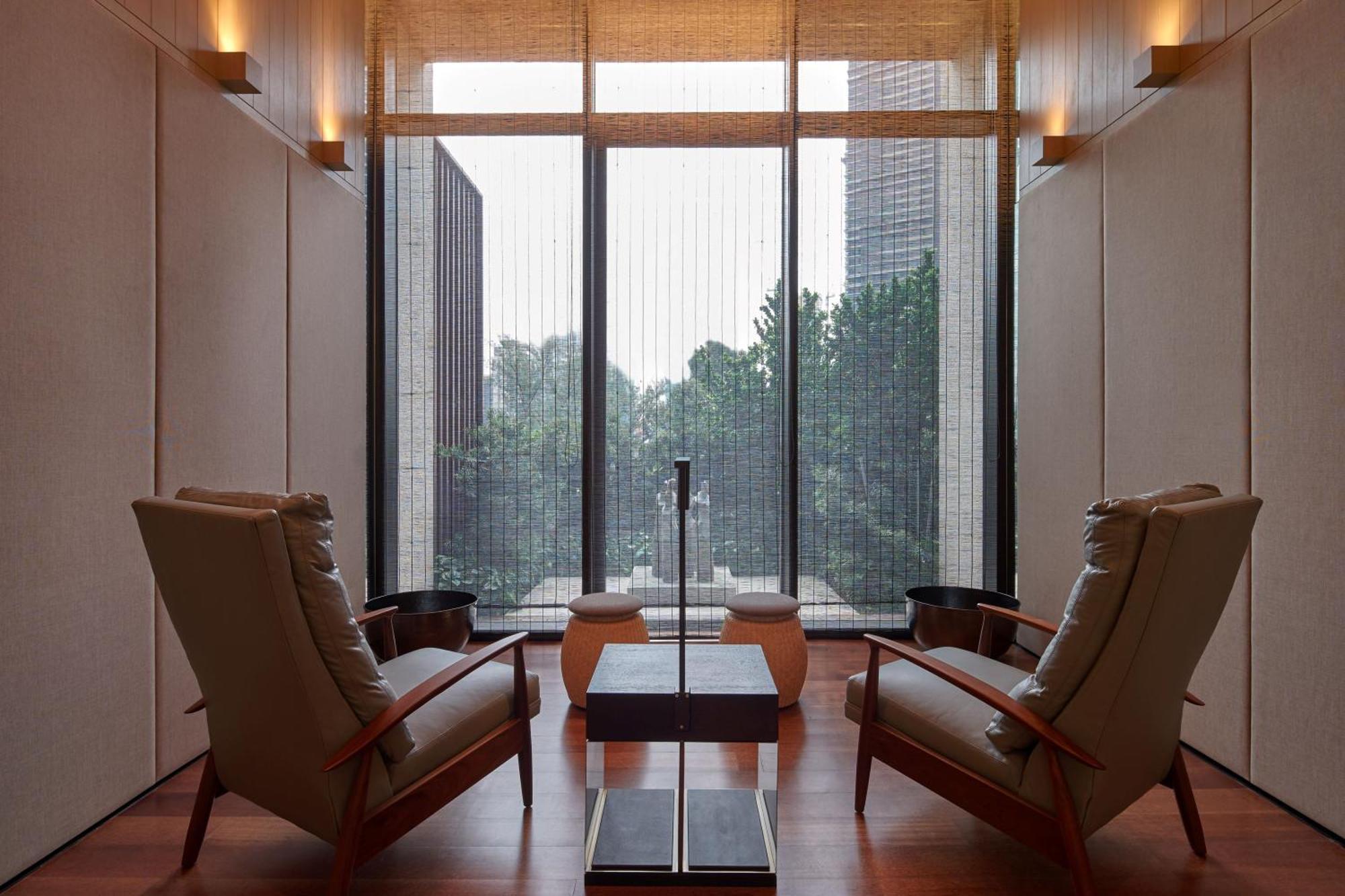 The Ruma Hotel And Residences Kuala Lumpur Exterior photo The photo depicts a minimalist interior space, featuring two stylish chairs positioned across from each other. Between them, there's a sleek table with a simple design. The walls are finished with a light color, contributing to a serene ambiance. Lar